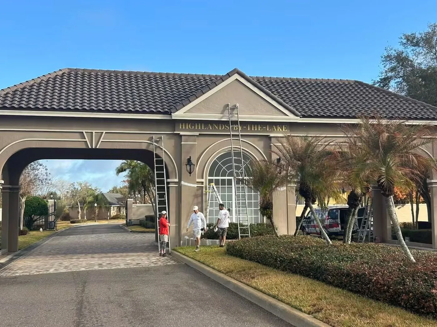 Mike's Painting crew repainting the entrance gatehouse at Highlands by the Lake in Lakeland