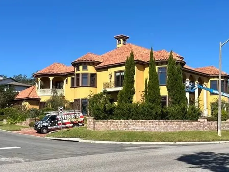 Mike's Painting vans parked at a Mediterranean-style home under exterior repaint in Lakeland